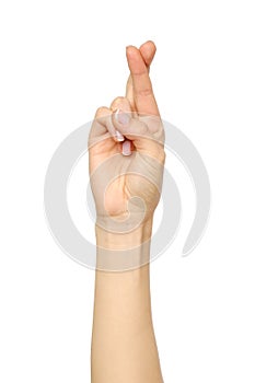 Woman`s hand showing crossed fingers lie symbol