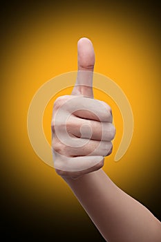 Woman`s hand showing thumbs up gesture. isolated on gradient background