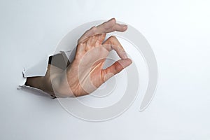 Woman& x27;s hand shows a circle with your fingers a white background.