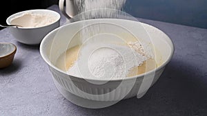 Woman's hand sifting flour through sieve. Baking, cooking, pastry concept. Top view.