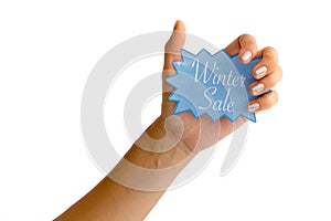 Woman's hand with silver fingernails holding a blue winter sale