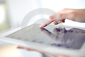 Woman's hand sliding on tablet's screen