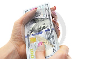 Woman`s hand with stack of dollars