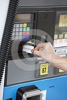 Woman's Hand Swiping Card At Fuel Station