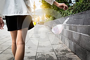 WomanÃ¢â¬â¢s hand throwing trash on the floor in public areas,female people disposed improperly throwing away garbage the way while