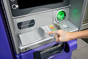 Woman`s hand using an ATM. Business woman using an atm machine