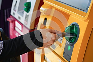 Woman`s hand using Credit Card to withdrawing or transfer money from Atm machine.Finance, money, bank concept