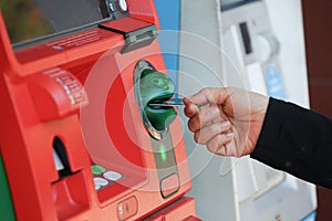 Woman`s hand using Credit Card to withdrawing or transfer money from Atm machine.Finance, money, bank concept