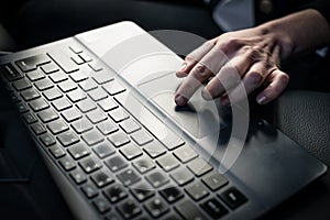 Woman`s hand using laptop keypad