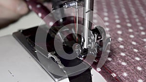 Woman`s hand using a sewing machine, close-up view