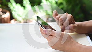 Woman`s hand is using a smart phone to search for information online