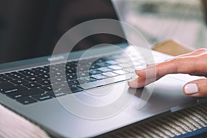 A woman`s hand using and touching on laptop touchpad