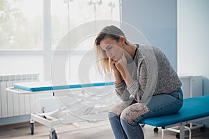 Woman`s hand waiting for doctor in hospital feeling worried.