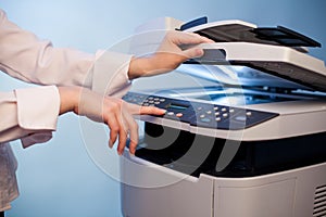 Woman's hand with working copier