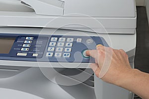 Woman's hand with working copier isolated