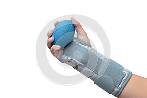 Woman`s hand with wrist support squeezing a soft ball