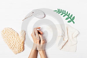 Woman's hands among accessories for skin exfoliation