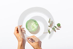 Woman's hands applying sample of aloe vera gel