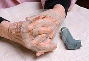 Woman's hands and asthma inhaler photo