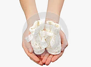 Woman's hands with baby's bootee