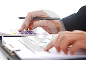 Woman's hands with a calculator and a pen