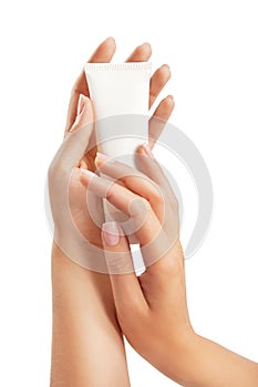 Woman's hands with care cream tube