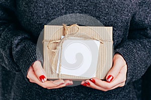 Woman`s hands with christmas gift box