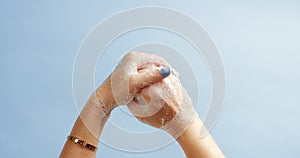 Woman`s hands closeup isolated on light blue