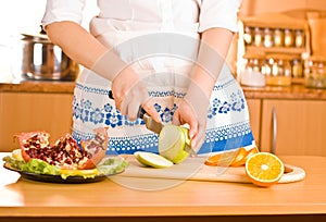 Woman's hands cutting apple