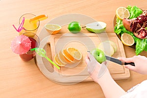 Woman's hands cutting apple