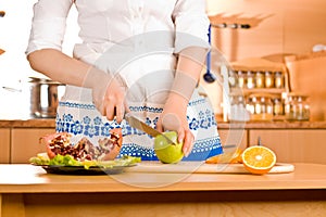 Woman's hands cutting apple