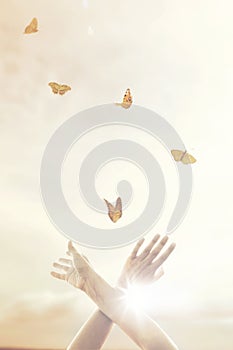 woman`s hands dance in harmony with some butterflies