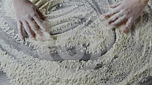 Woman's hands are drawing abstract shapes on a table from natural flour. Slow motion, Full HD video, 240fps, 1080p