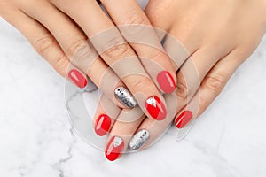 Woman& x27;s hands with fashionable red manicure. Christmas new year nail design.