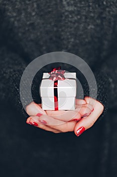 Woman`s hands with gift box