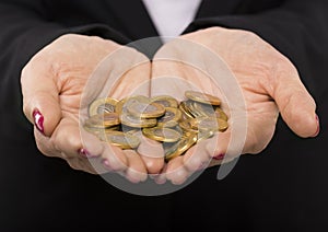 Woman's hands with a gold coins