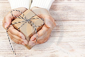 Woman& x27;s hands hold christmas or new year decorated gift box