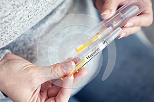 Woman`s hands hold disposable syringe