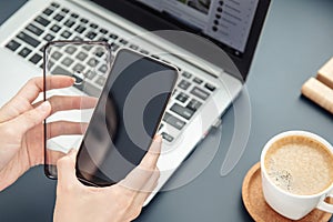 Woman`s hands hold smartphone