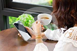 Woman`s hands holding black mobile phone