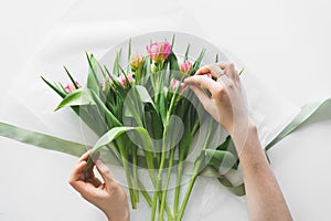 Woman& x27;s hands holding bouquet of beautiful delicate tulip