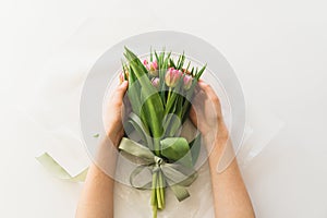 Woman& x27;s hands holding bouquet of beautiful delicate tulip