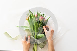 Woman& x27;s hands holding bouquet of beautiful delicate tulip