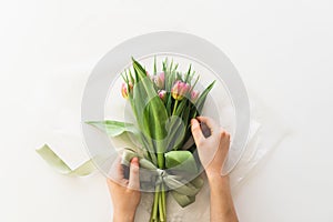 Woman& x27;s hands holding bouquet of beautiful delicate tulip