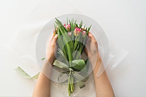 Woman& x27;s hands holding bouquet of beautiful delicate tulip