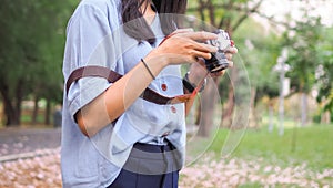 WOman`s hands holding an camera at nature background