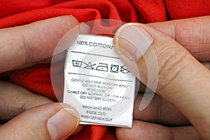 Woman's hands holding clothes label
