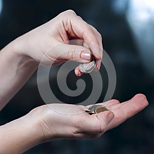 Woman's hands holding coins, russian rubles