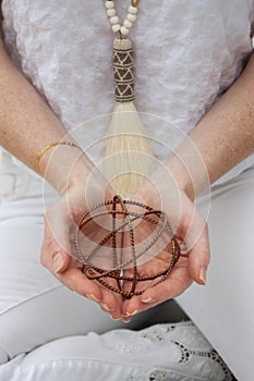 Woman`s Hands Holding Decorative Wire Ball