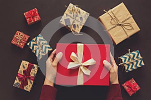 Woman`s hands holding gift box. Present boxes background